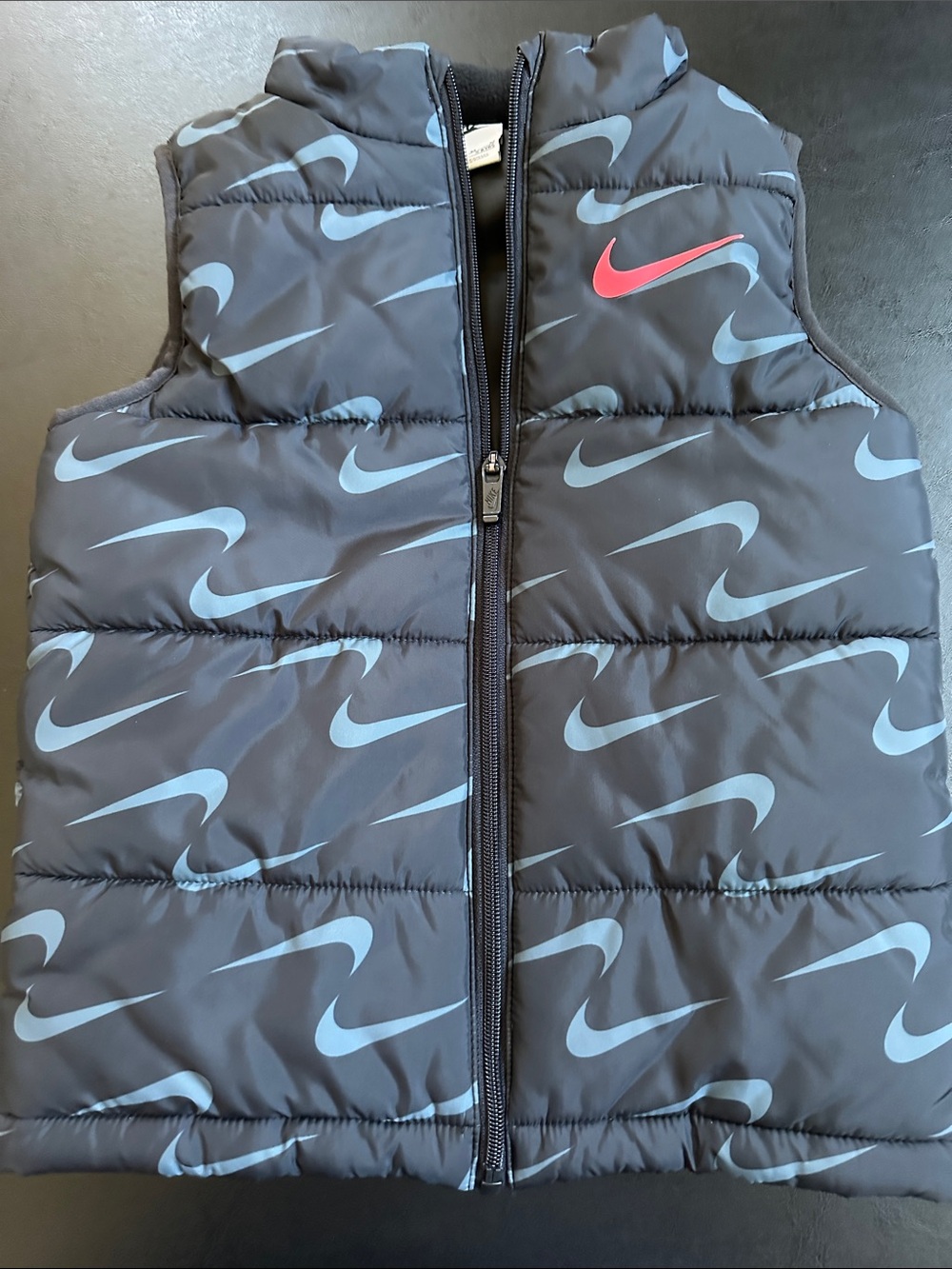 Nike Black Puffer Vest with Light Blue Swoosh Pattern and Pink Logo